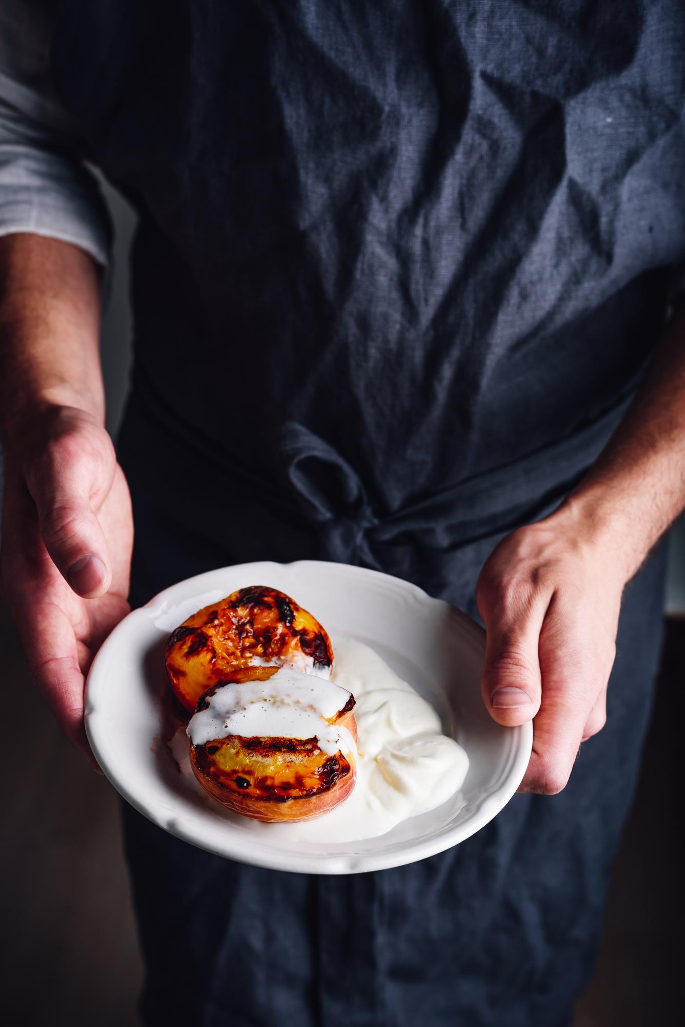 Chef demonstrating plating in a calm studio